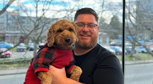 Dr. Cody Sandzimier, creator of the Looptimer visual timer, holding his dog Pax