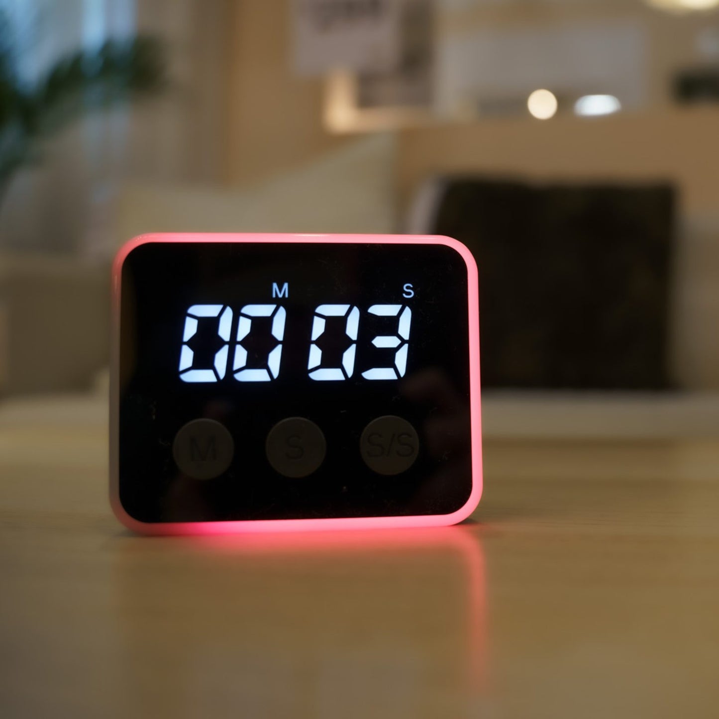 Close-up of Looptimer visual timer glowing red with 3 seconds remaining on a wooden surface