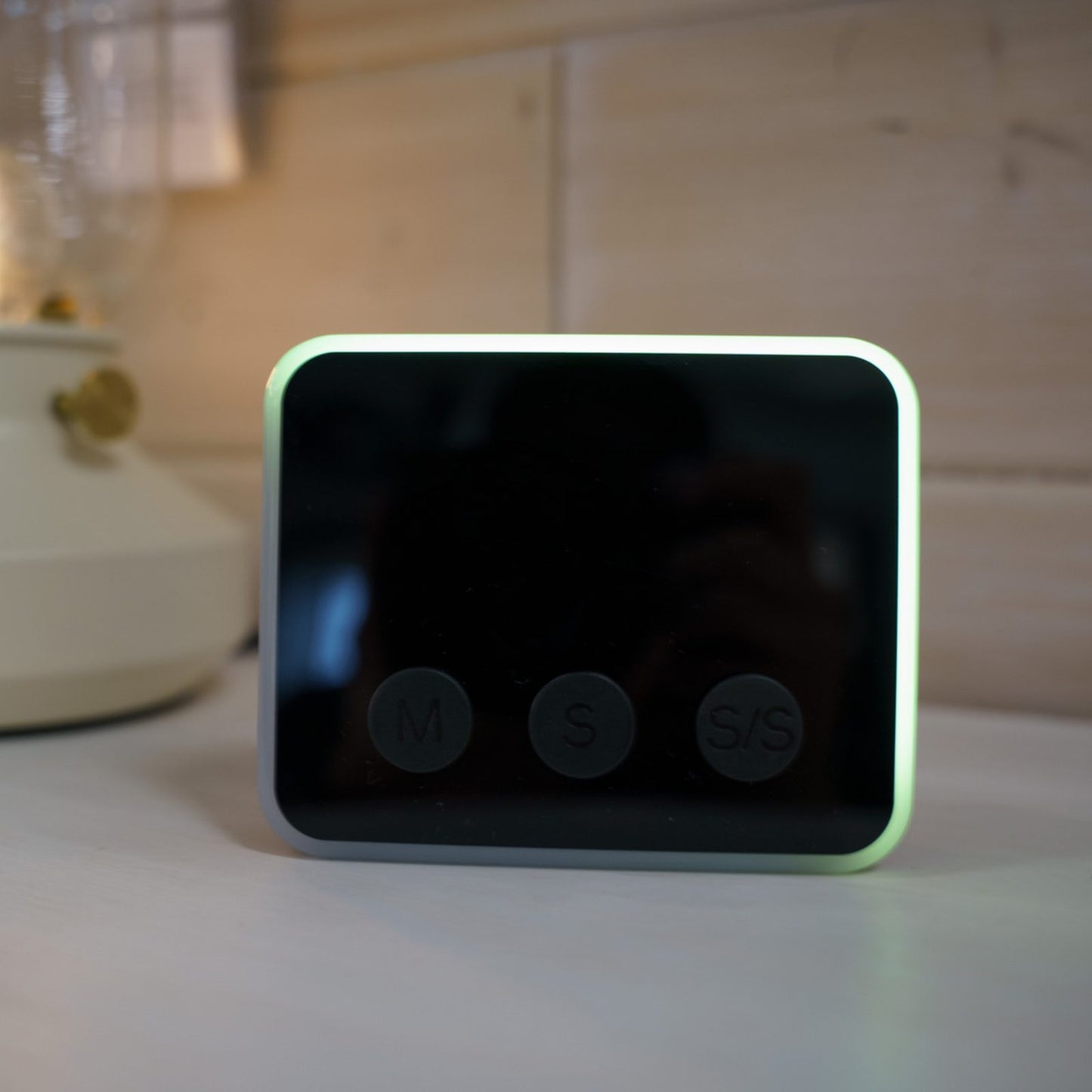 Looptimer visual timer in black with time display turned off and only showing green LED light glowing around the perimeter