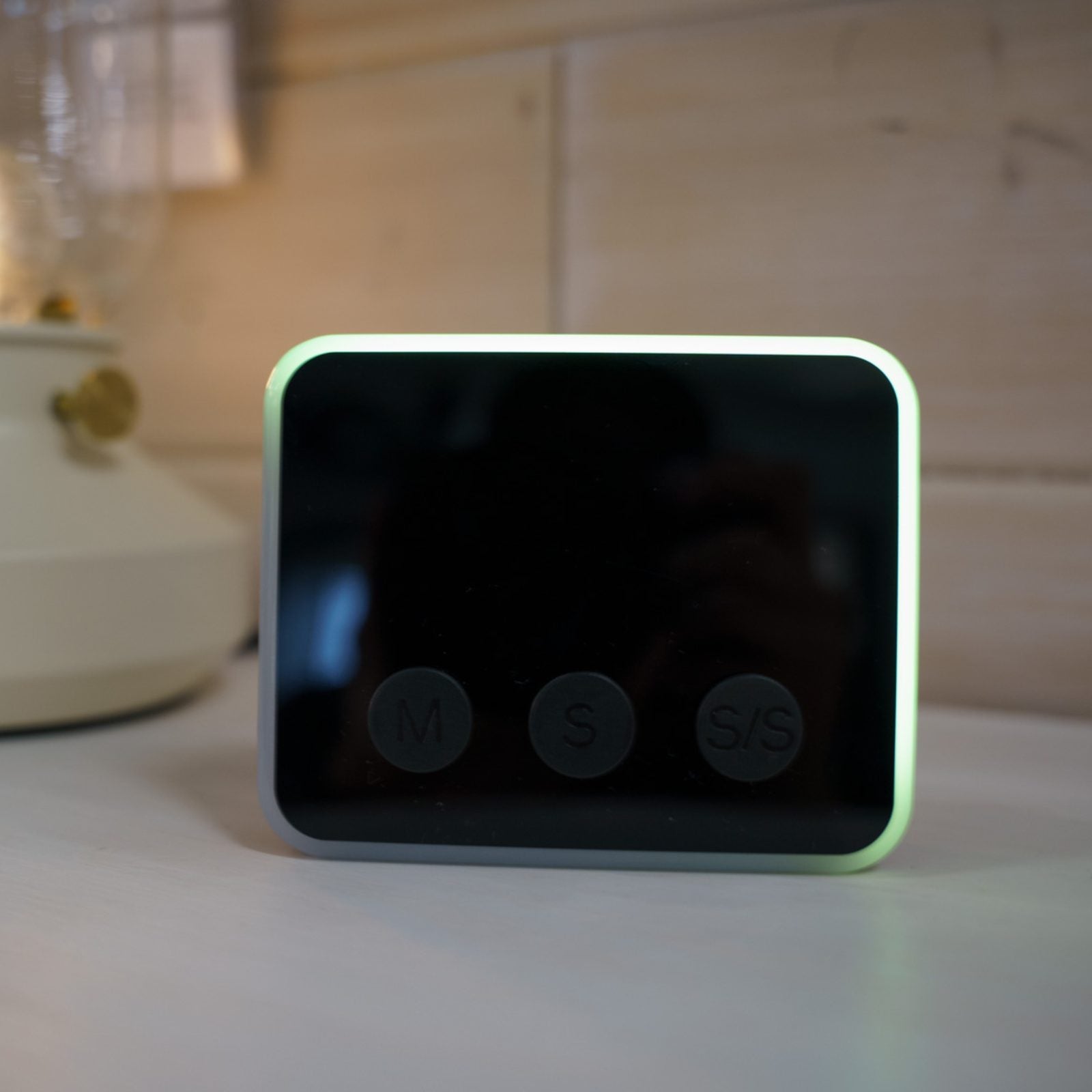 Looptimer visual timer in black with time display turned off and only showing green LED light glowing around the perimeter